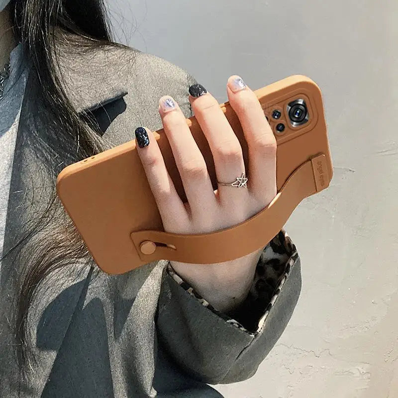 a woman holding a phone case in her hand