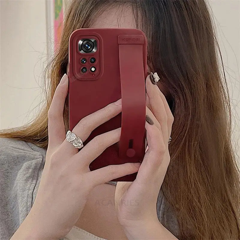 a woman holding a red phone case