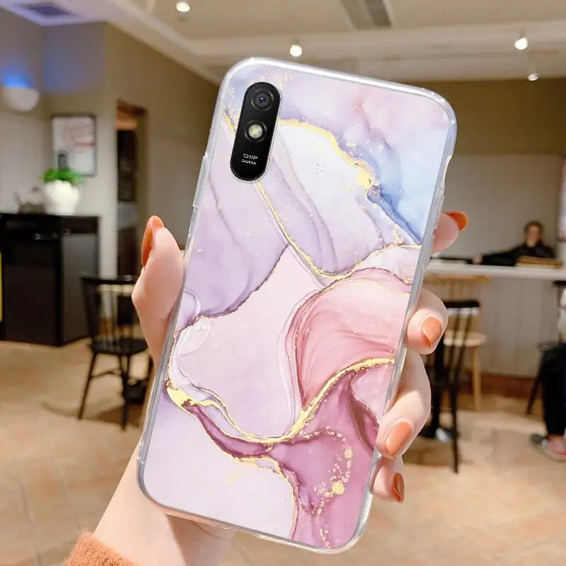 a woman holding a phone case with a marble pattern