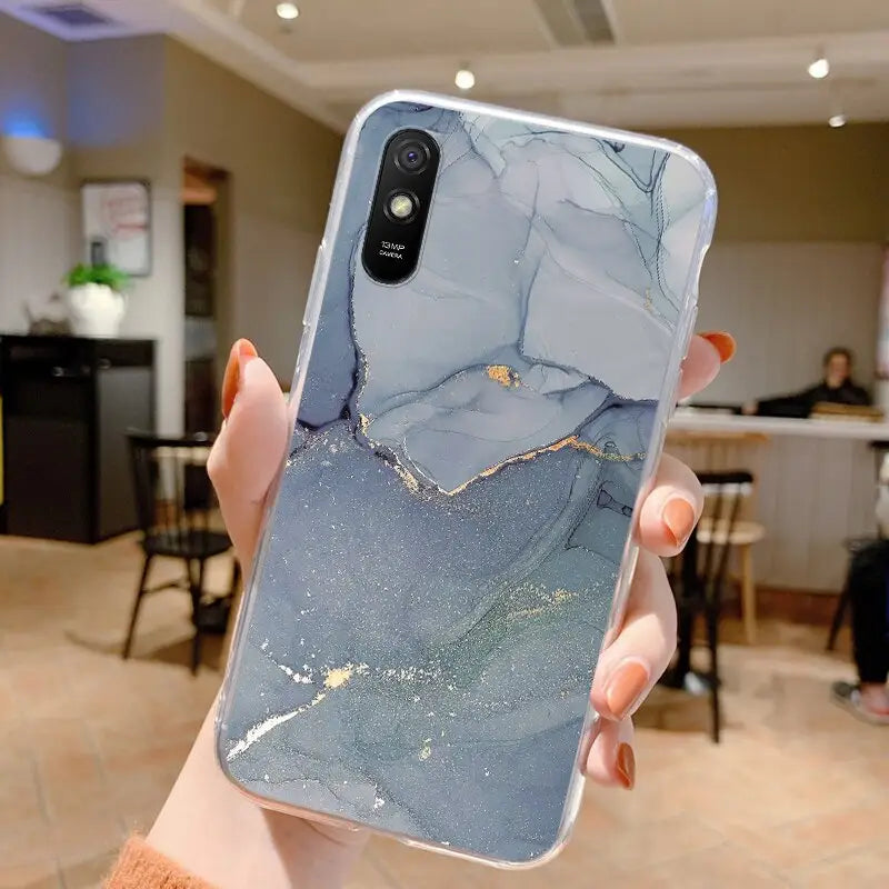 a person holding up a phone case with a marble pattern
