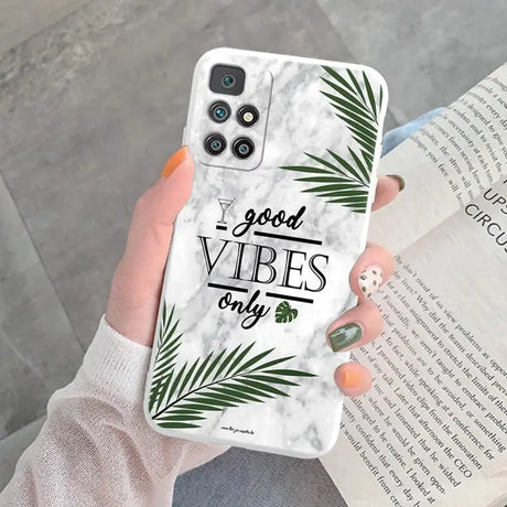 a woman holding a phone case with the words good vibe on it