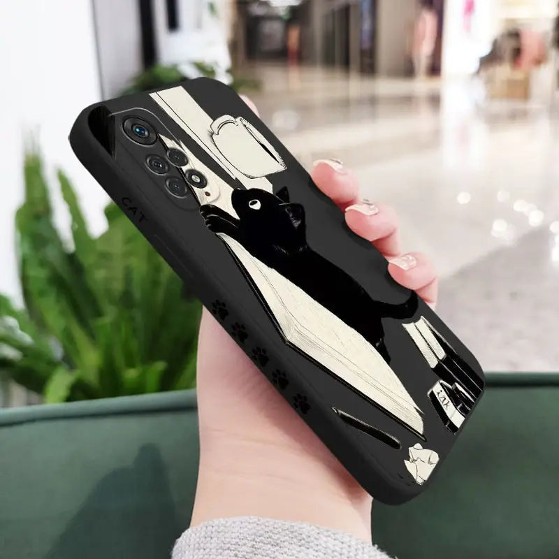 a woman holding a phone case with a black and white car