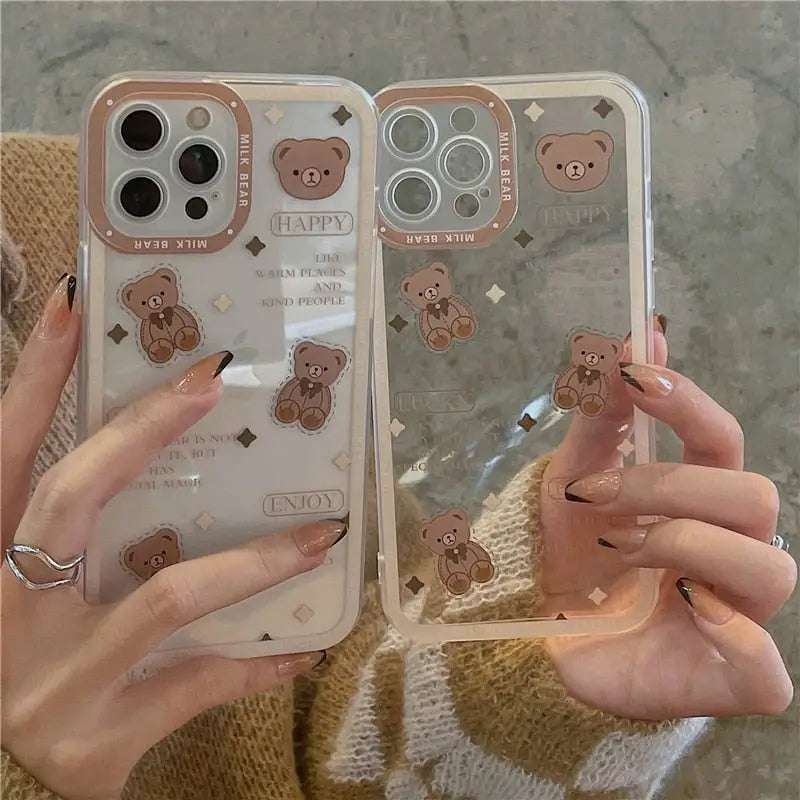 a woman holding a phone case with a bear design