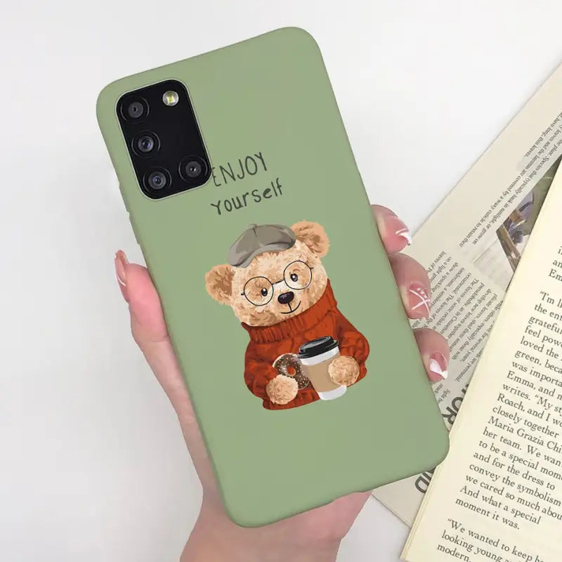 a woman holding a phone case with a bear
