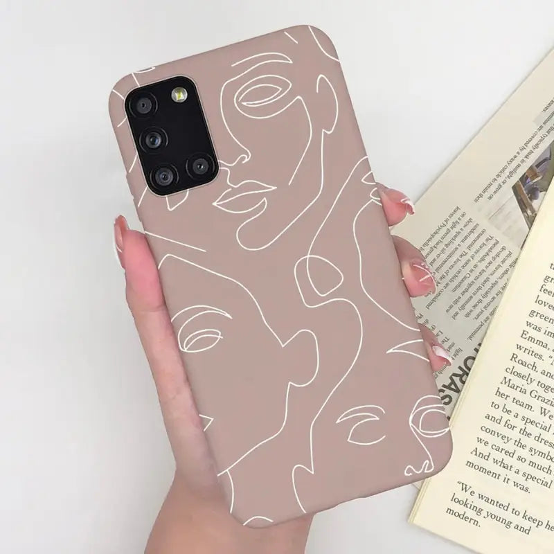 a woman holding a book and a phone case