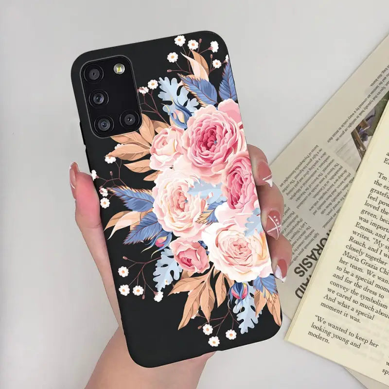 a woman holding a phone case with flowers on it