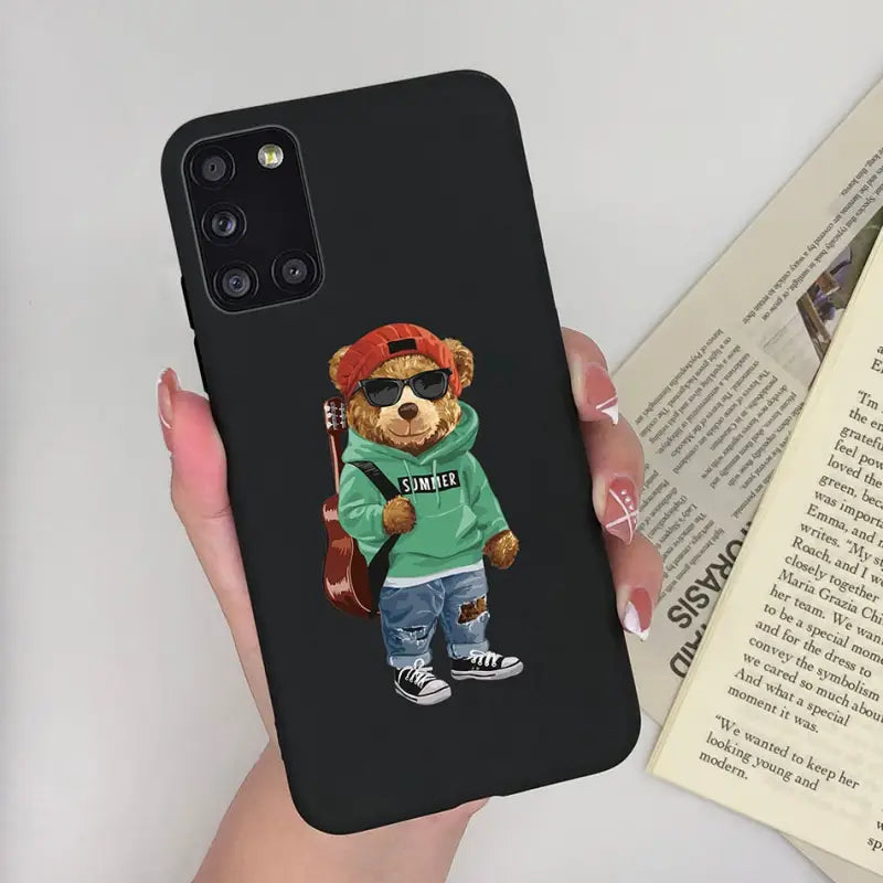 a person holding a phone case with a bear