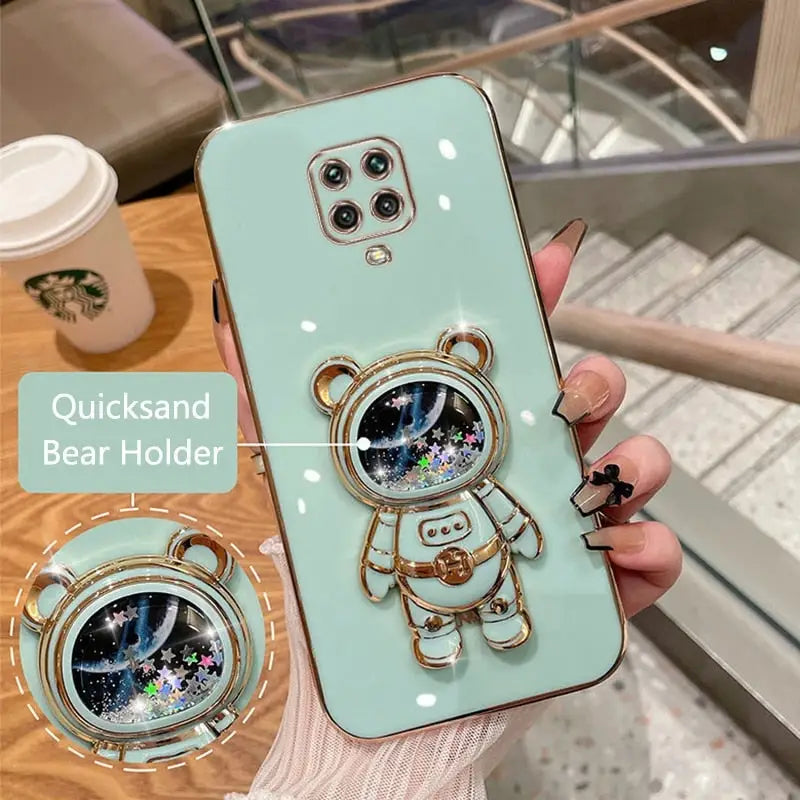 a woman holding a phone case with a picture of a cat