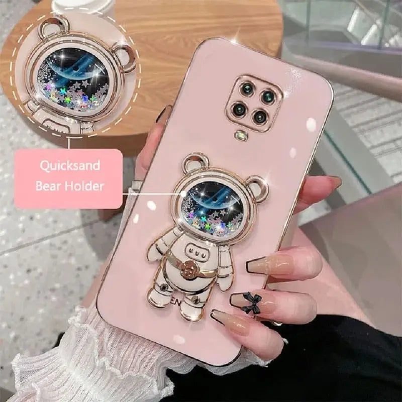 a woman holding a phone case with a bear design