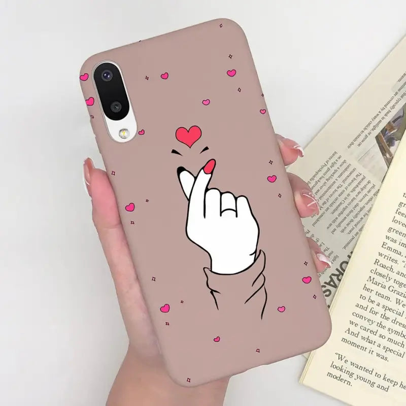 a woman holding a phone case with a heart on it