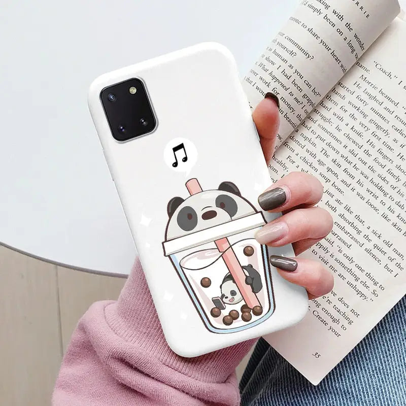 a woman holding a phone case with a cartoon character