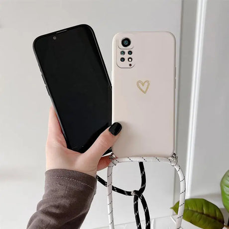 a woman holding a phone with a heart on it