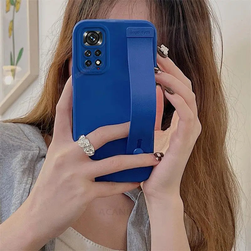a woman holding a phone in her hand