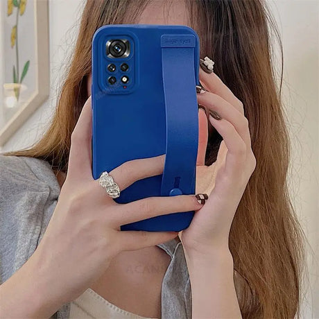 a woman holding a phone in her hand