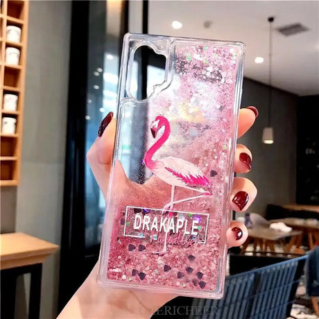 a woman holding a pink flaming phone case