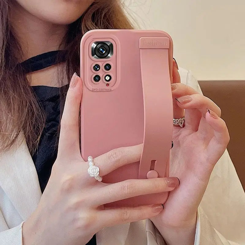 a woman holding a pink iphone case