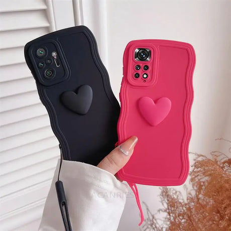 a woman holding a pink iphone case with a heart on it