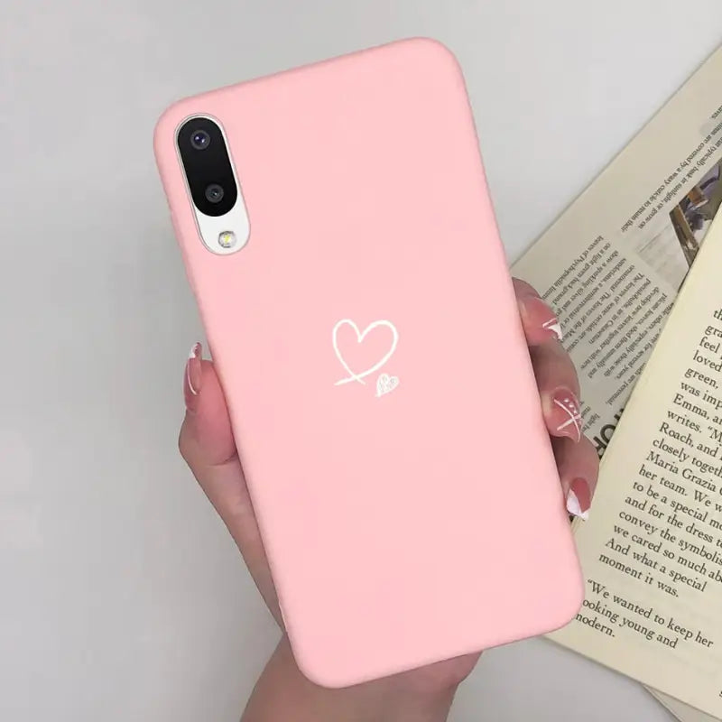 a woman holding a pink iphone case