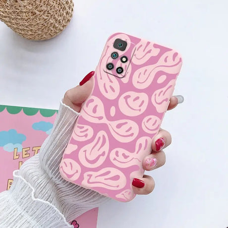 a woman holding a pink phone case