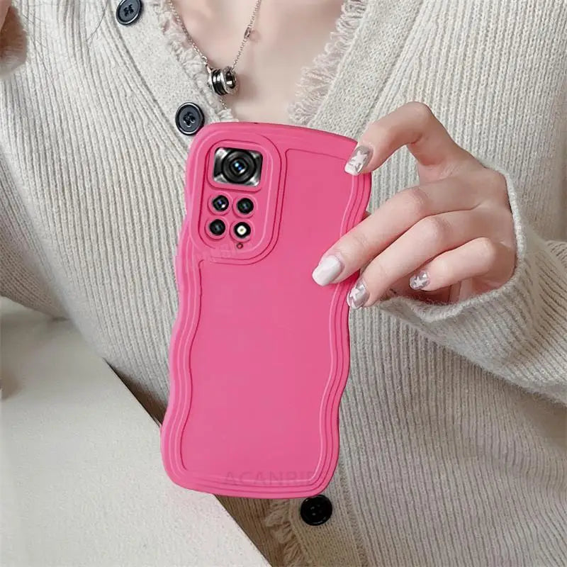 a woman holding a pink phone case