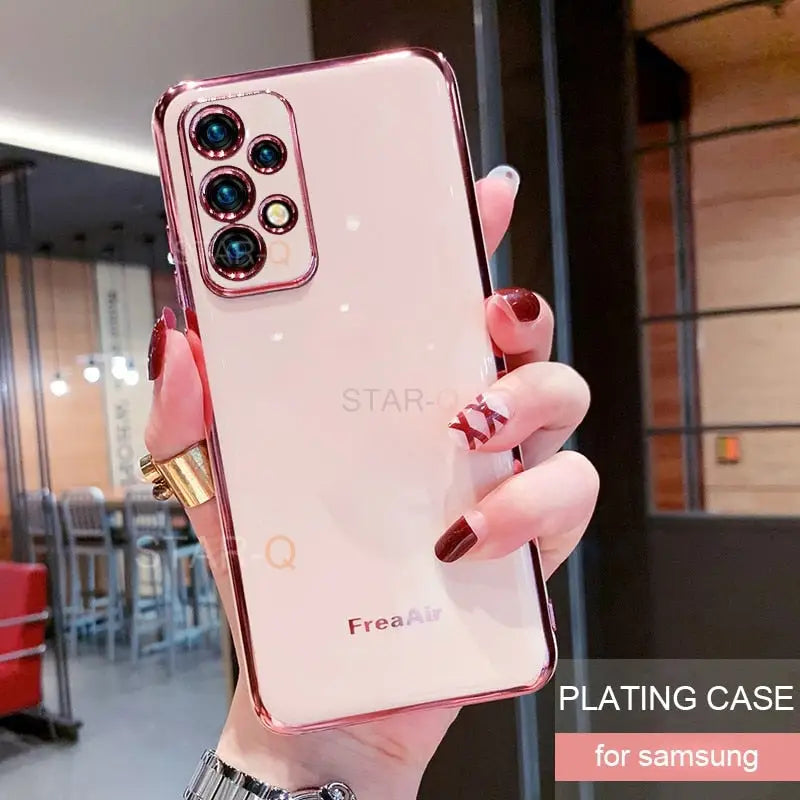 a woman holding up a pink phone case