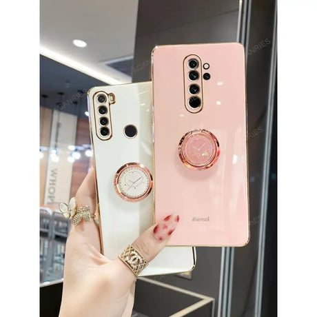 a woman holding a pink and white phone case