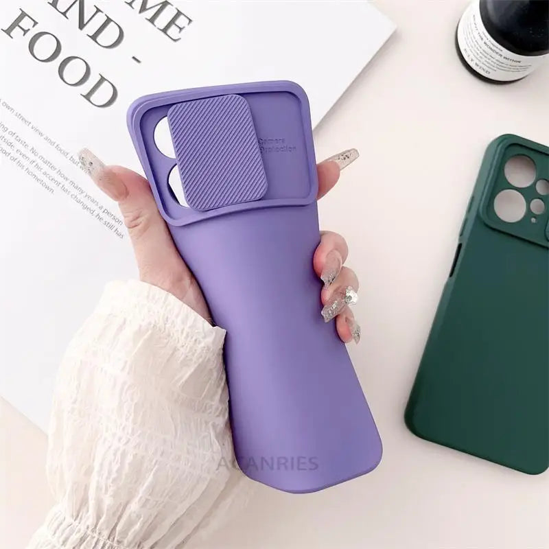 a woman holding a purple phone case