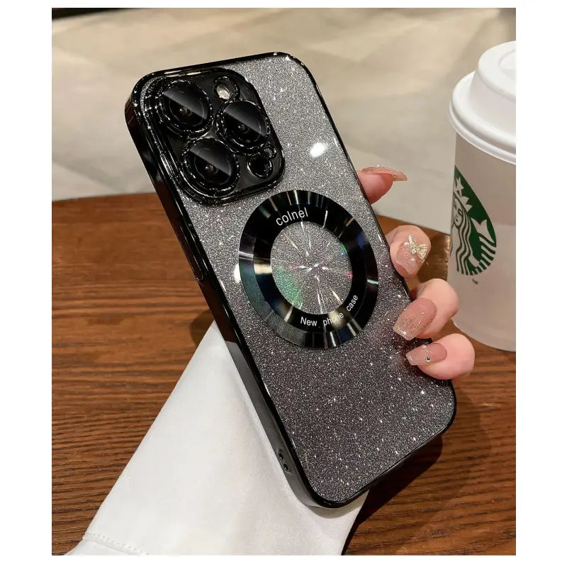 a woman holding a black phone case with a clock on it
