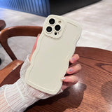 a woman holding a white iphone case