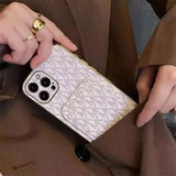 a woman holding a white phone case with a gold ring