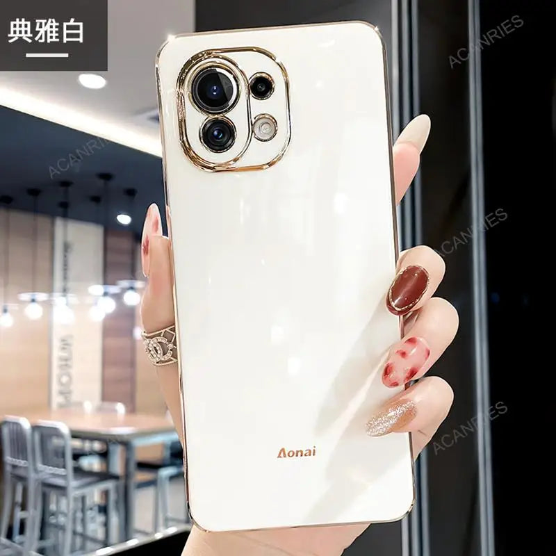 a woman holding a white phone case