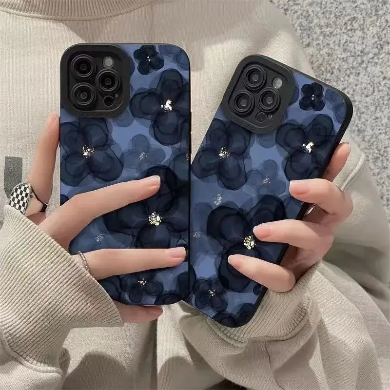 A woman holding a phone case with a blue floral pattern