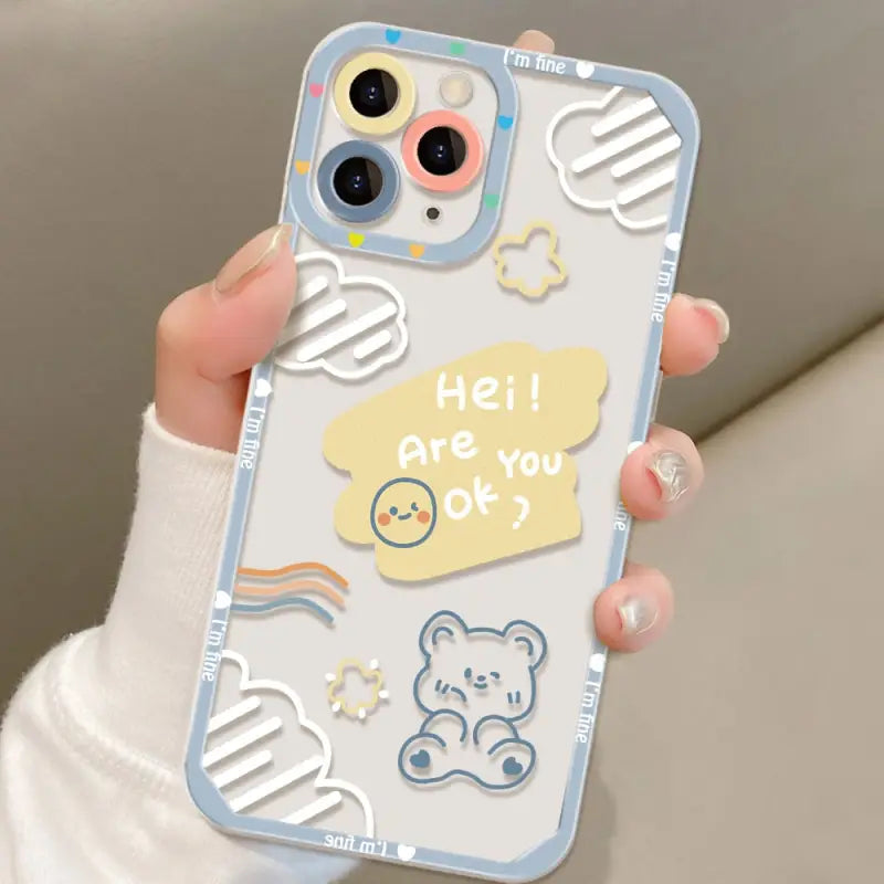 a woman holding a phone case with a cartoon character design