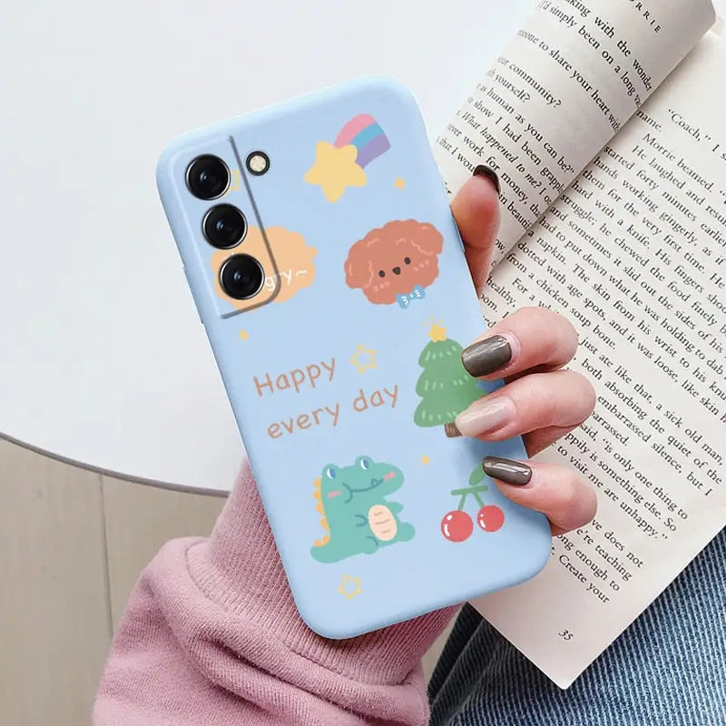 a woman holding a phone case with a cartoon design