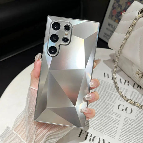 A woman holding a phone case with a diamond design