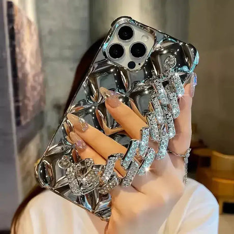 a woman holding a phone case with diamonds