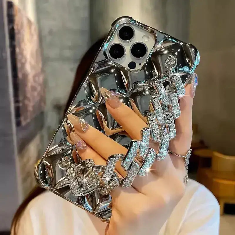 A woman holding a phone case with diamonds