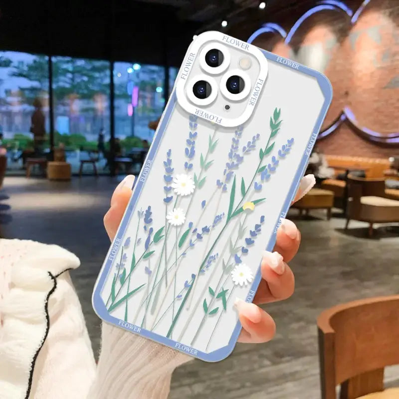 A woman holding a phone case with a flower design