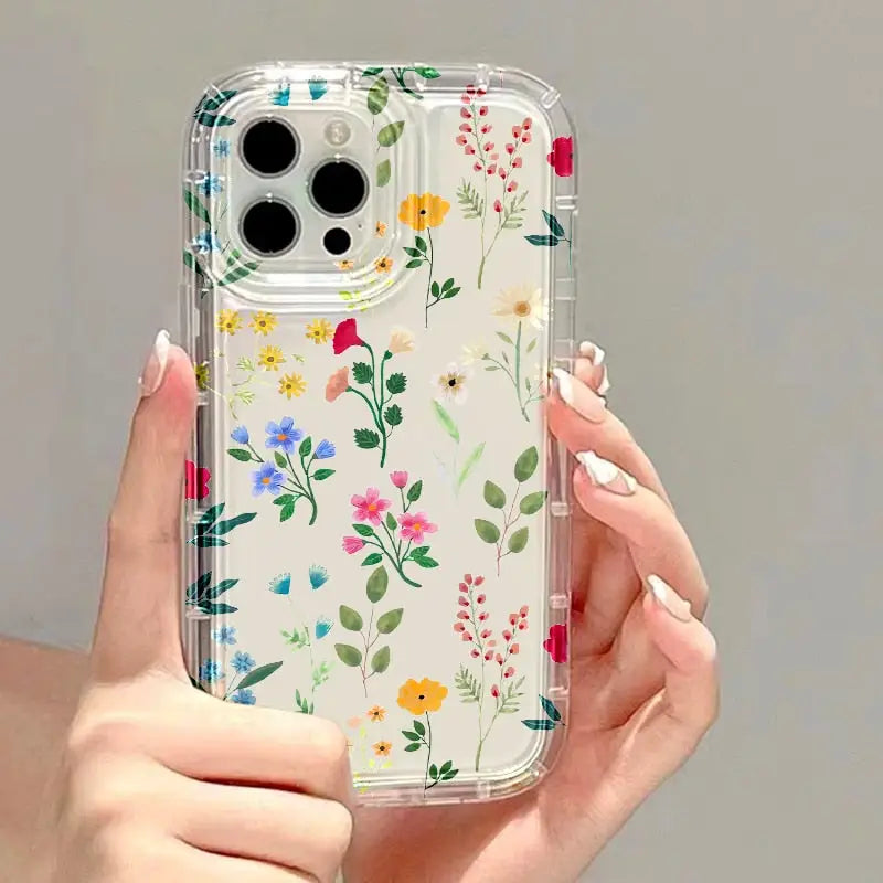 a woman holding a phone case with flowers on it