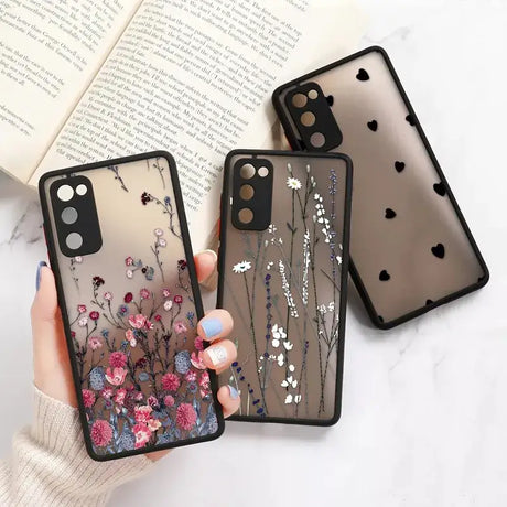 A woman holding a phone case with flowers on it