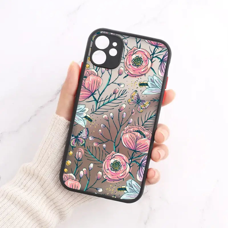 A woman holding a phone case with flowers on it