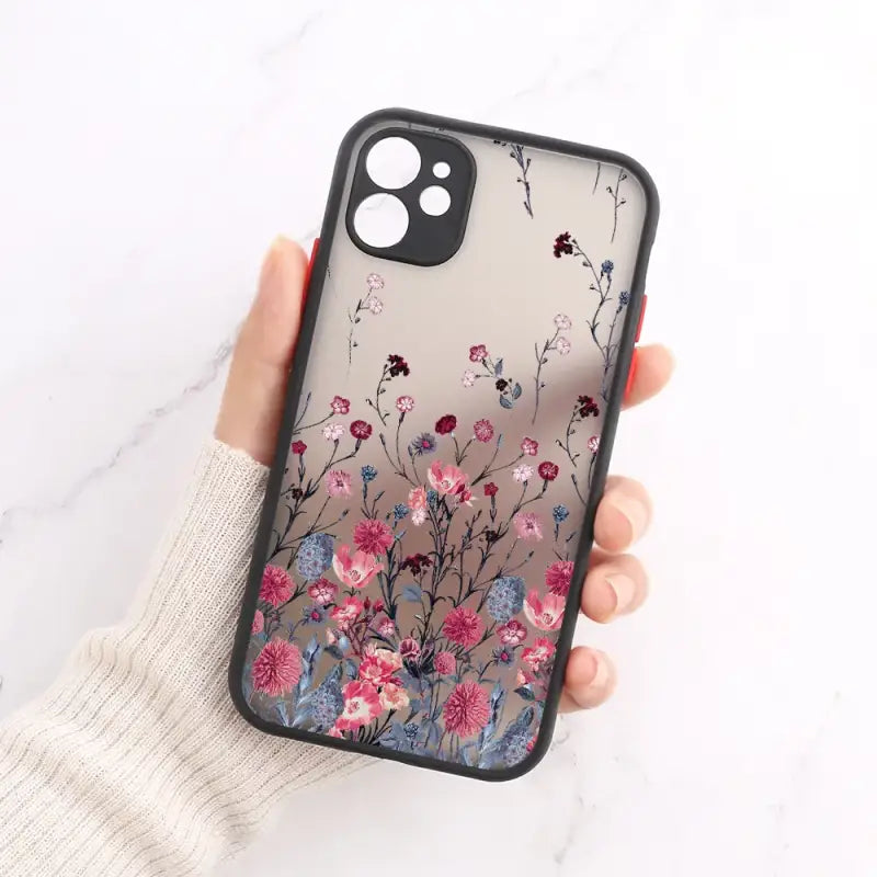 A woman holding a phone case with flowers on it