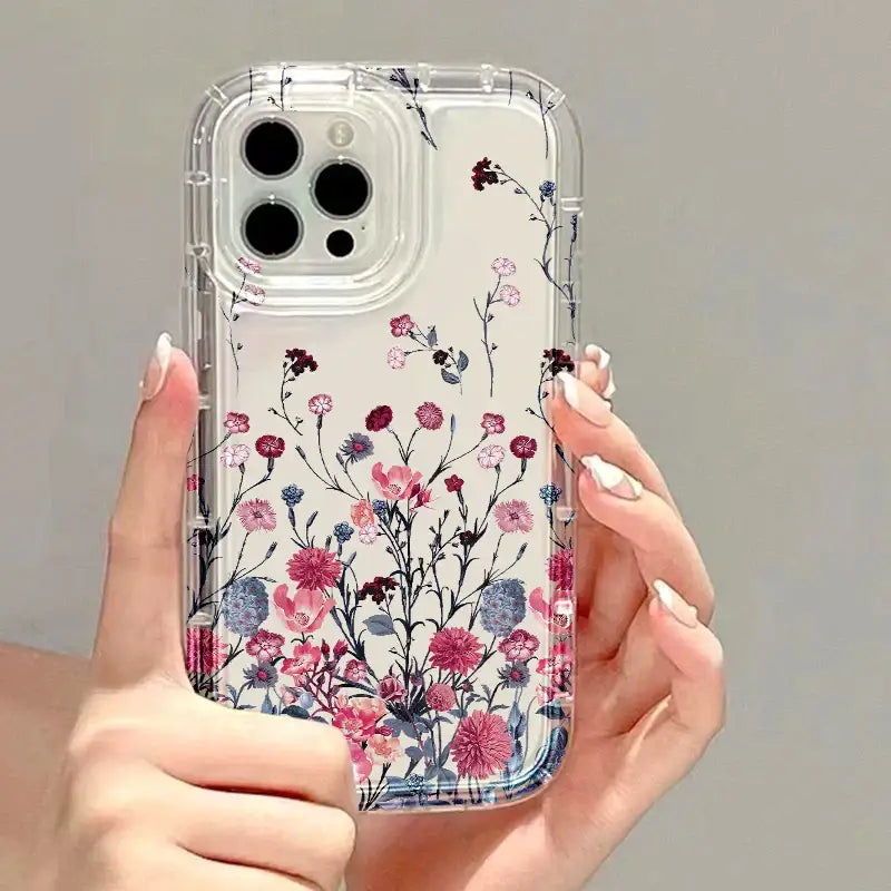 A woman holding a phone case with flowers on it
