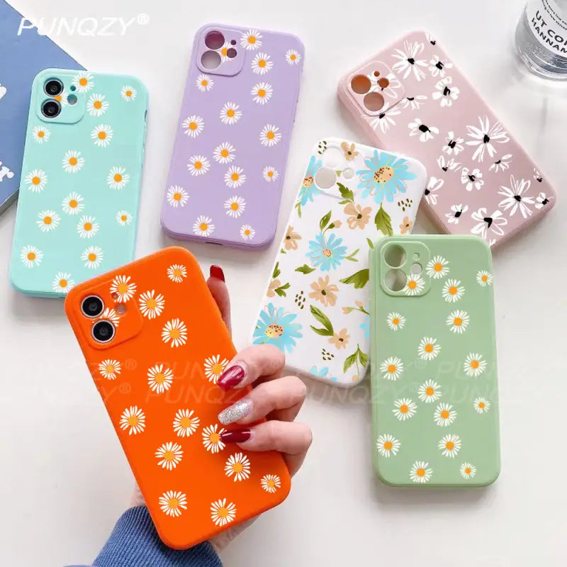 A woman holding a phone case with flowers on it