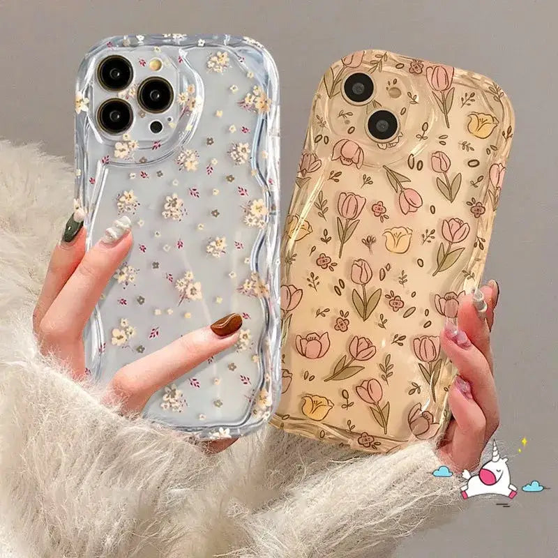 A woman holding a phone case with flowers on it