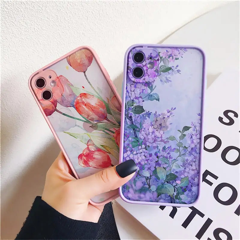 a woman holding a phone case with flowers on it