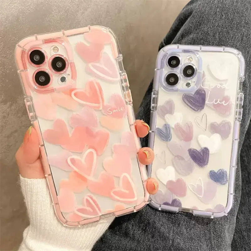 A woman holding a phone case with hearts on it