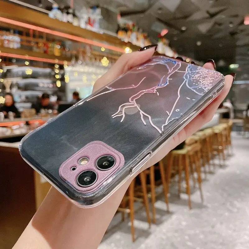A woman holding up a phone case with a drawing of a horse on it