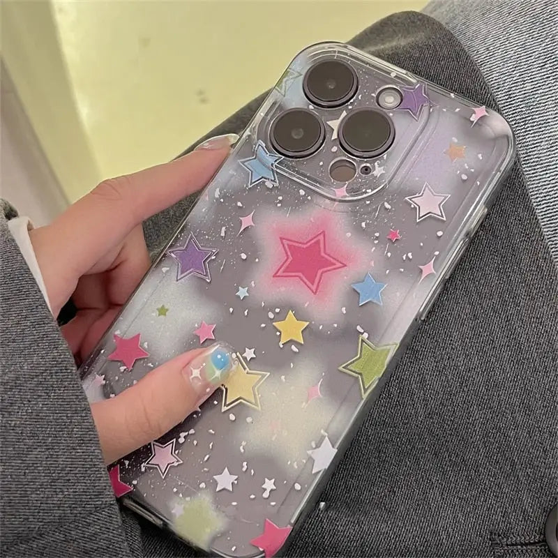 A woman holding a phone case with stars on it