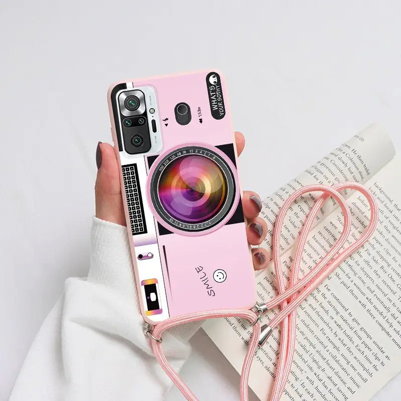 a woman holding a pink camera case